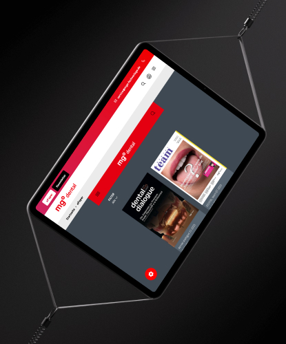 Tablet zeigt die Website von MGO DENTAL mit verschiedenen Zahnarzt-Fachmagazinen auf dem Bildschirm.