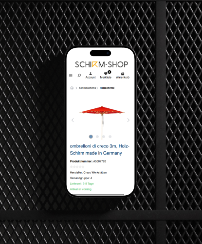 Shirm-Shop Referenz Mockup Mobil Ein Smartphone liegt flach auf einer dunklen Oberfläche. Auf dem Bildschirm des Smartphones ist der Shirm-Shop abgebildet.